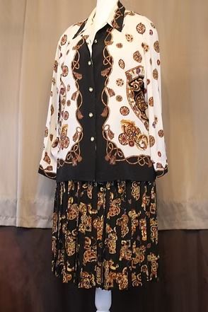 Patterned white jacket over black dress with floral skirt on a mannequin