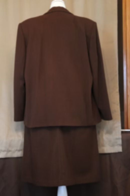 Brown tailored jacket and matching skirt displayed on a mannequin against a neutral backdrop