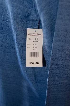 Blue tunic and skirt outfit displayed on a mannequin against a patterned backdrop