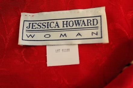 Red textured jacket with black trim on a dress form