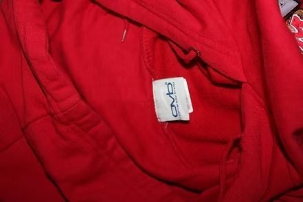 Mannequin wearing a red Maryland hoodie and blue pants against a patterned curtain backdrop
