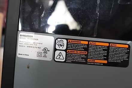 Compact gray-and-black air purifier on a carpeted floor