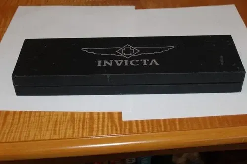 Invicta watch band display with four interchangeable straps in blue, red, gray, and yellow
