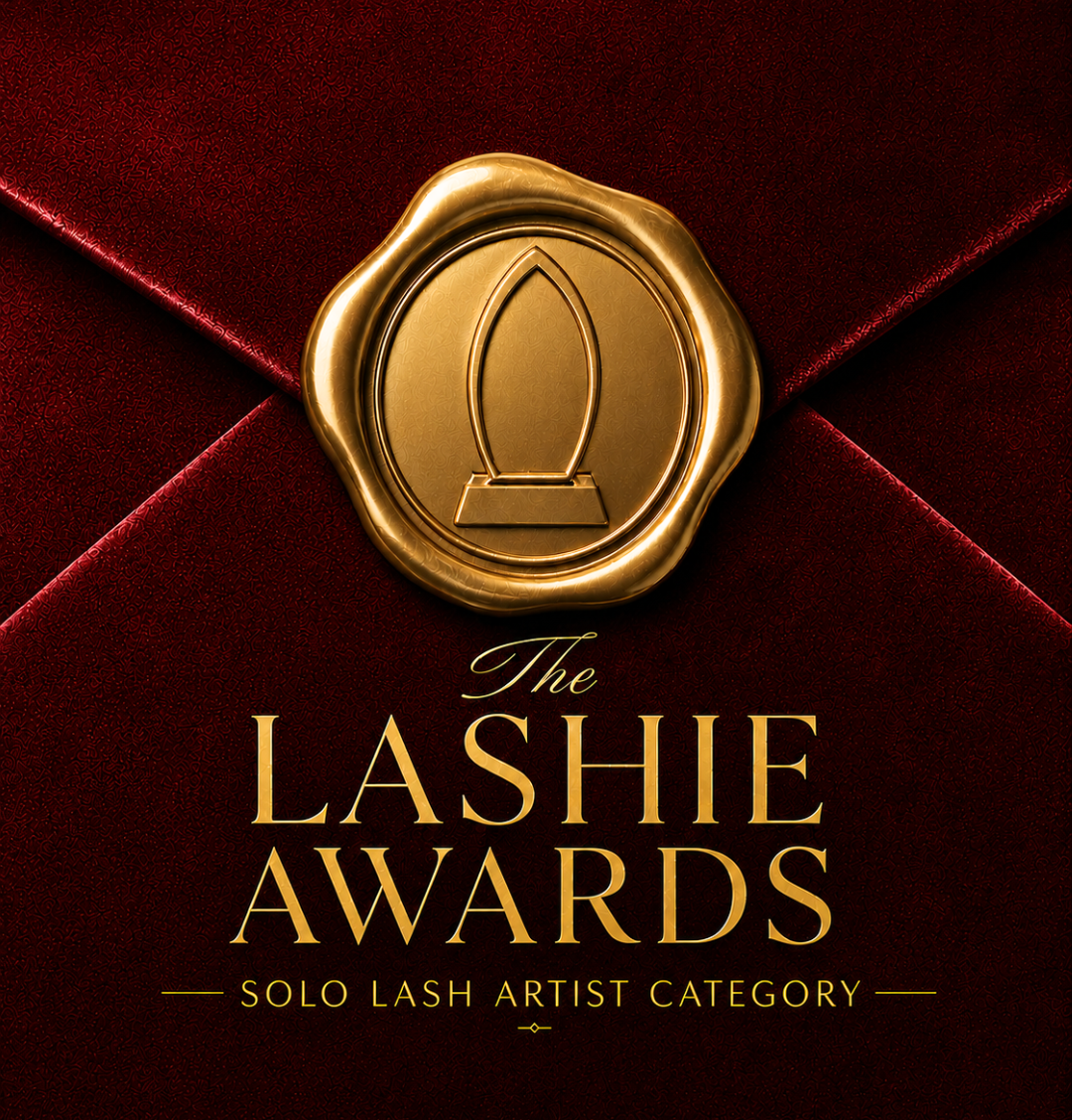 Gold Lashie Awards emblem on deep red velvet background, labeled “Solo Lash Artist Category”