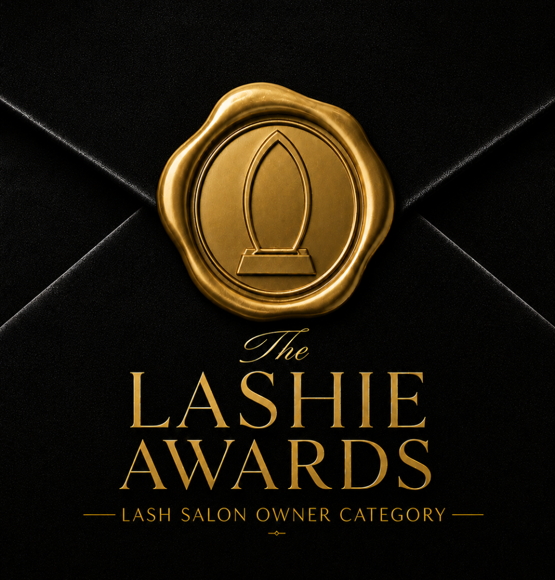 Gold seal logo for The Lashie Awards, Lash Salon Owner Category, on a black background