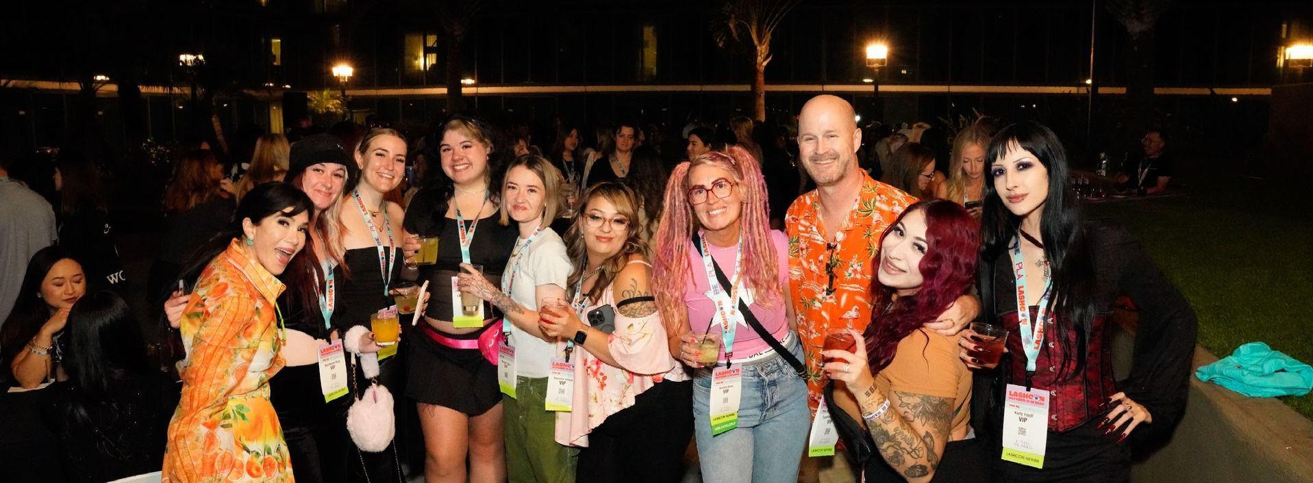 A group of people are posing for a picture together at night.