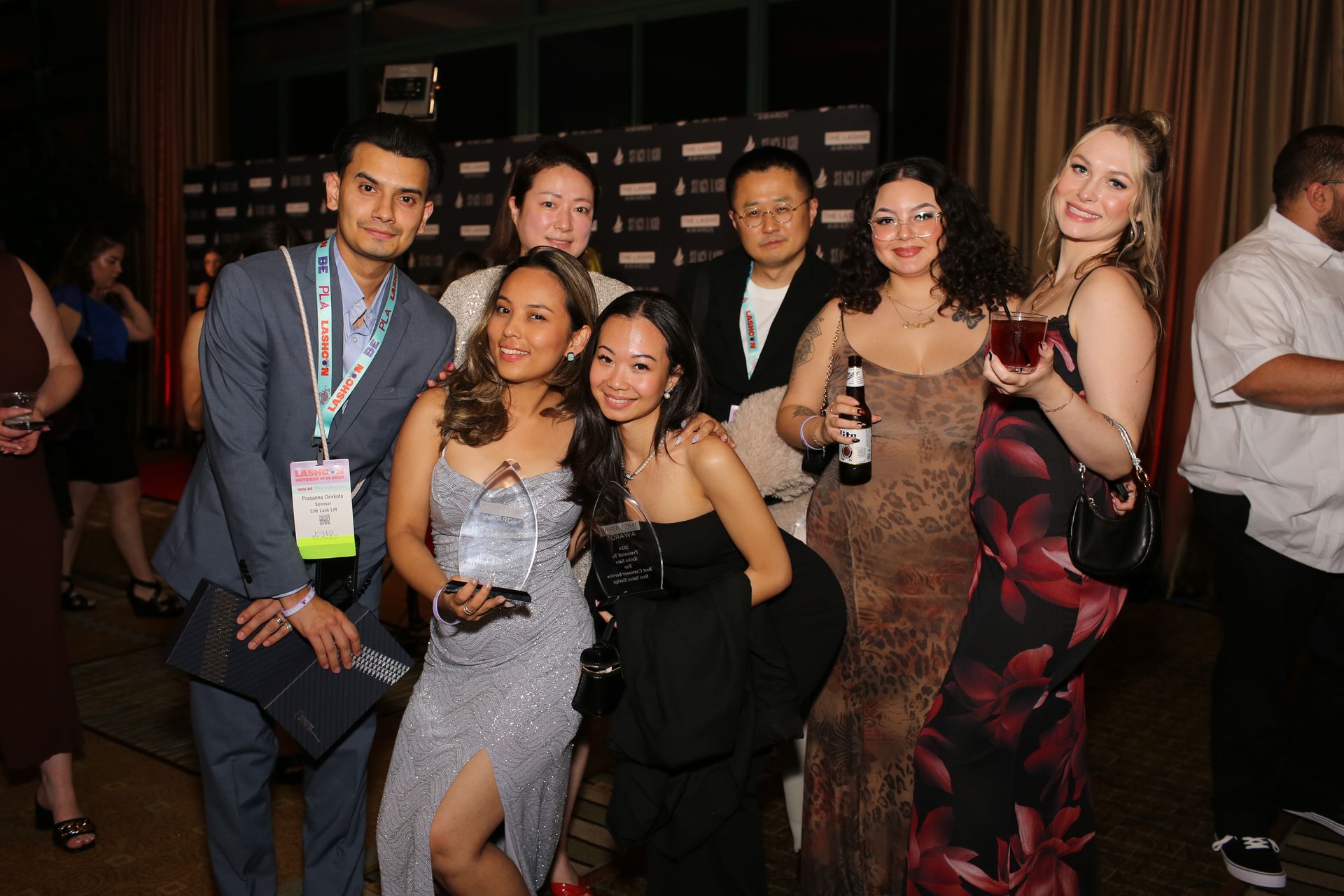A group of people are posing for a picture at a party.