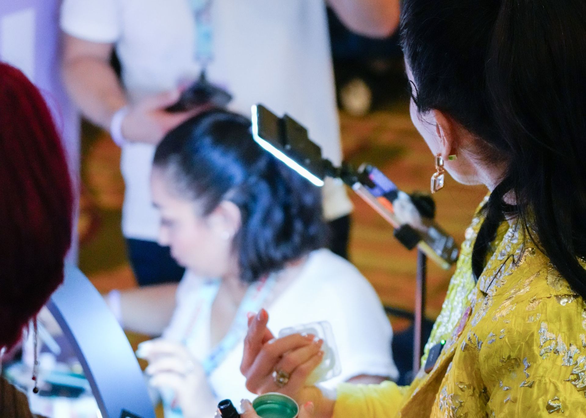 A woman is sitting at a table with a microphone in her hand.