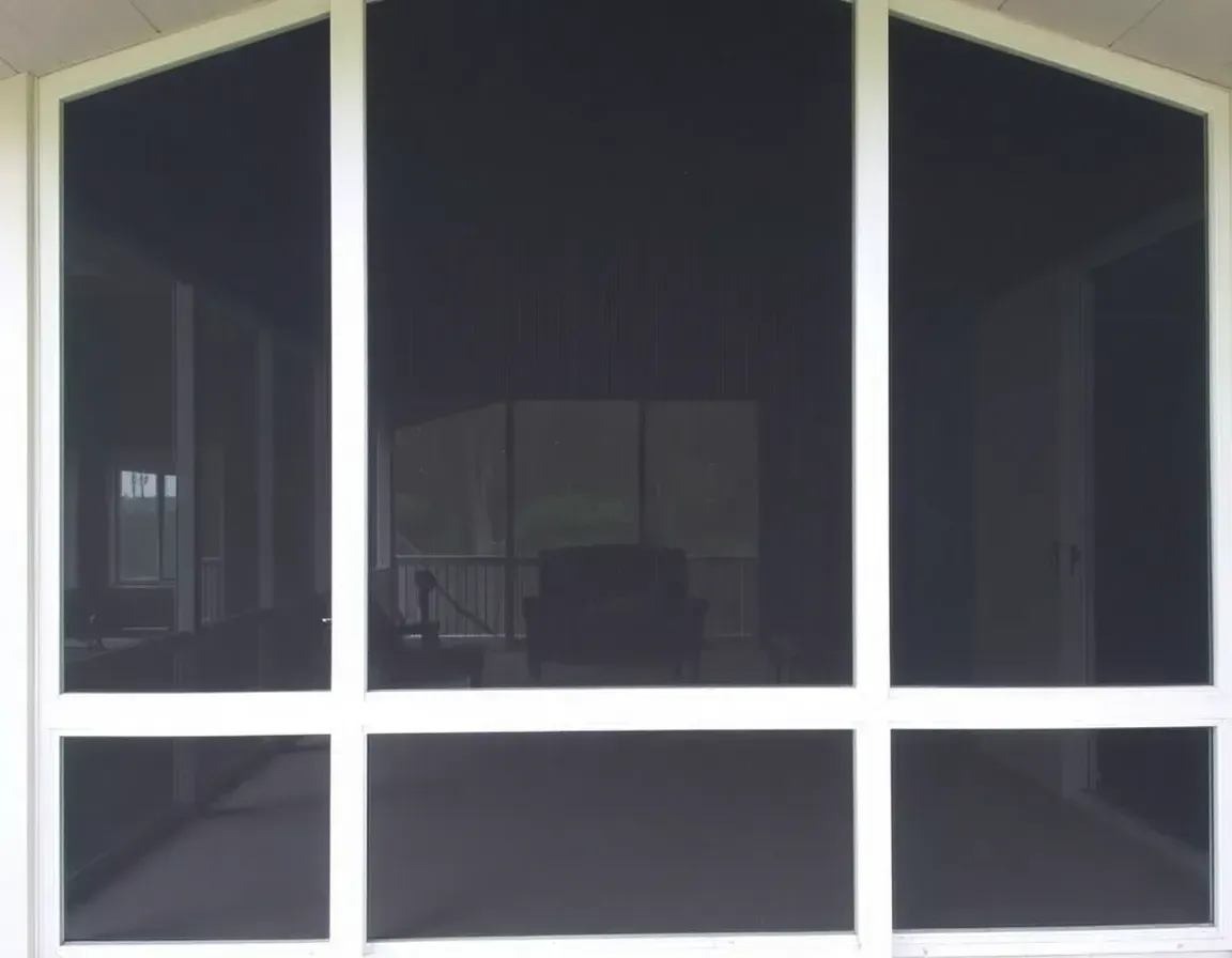 Dark windowed storefront with white framing and reflections in the glass