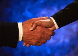Handshake between two people in business suits.