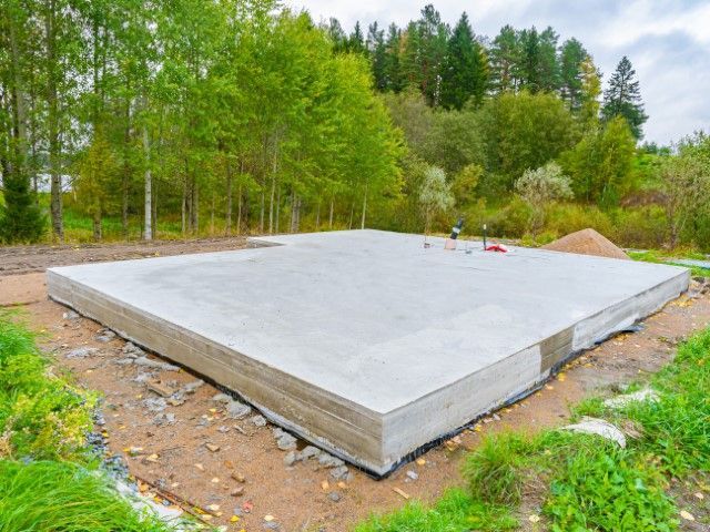Concrete foundation slab on a wooded construction site