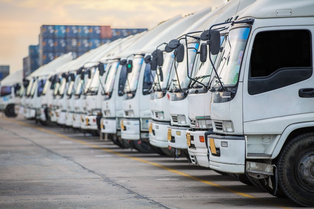 A Row of White Trucks Are Parked in a Parking Lot — Central Coast Storage Solutions in Gosford, NSW