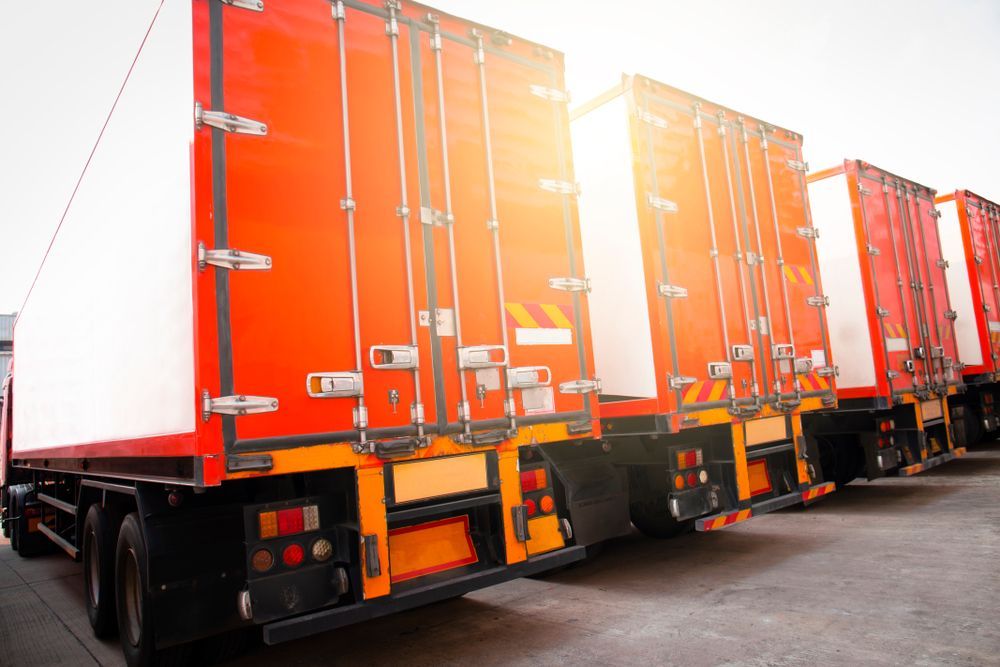 A Row of Red Semi Trucks Parked Next to Each Other in a Parking Lot — Central Coast Storage Solutions in West Gosford, NSW