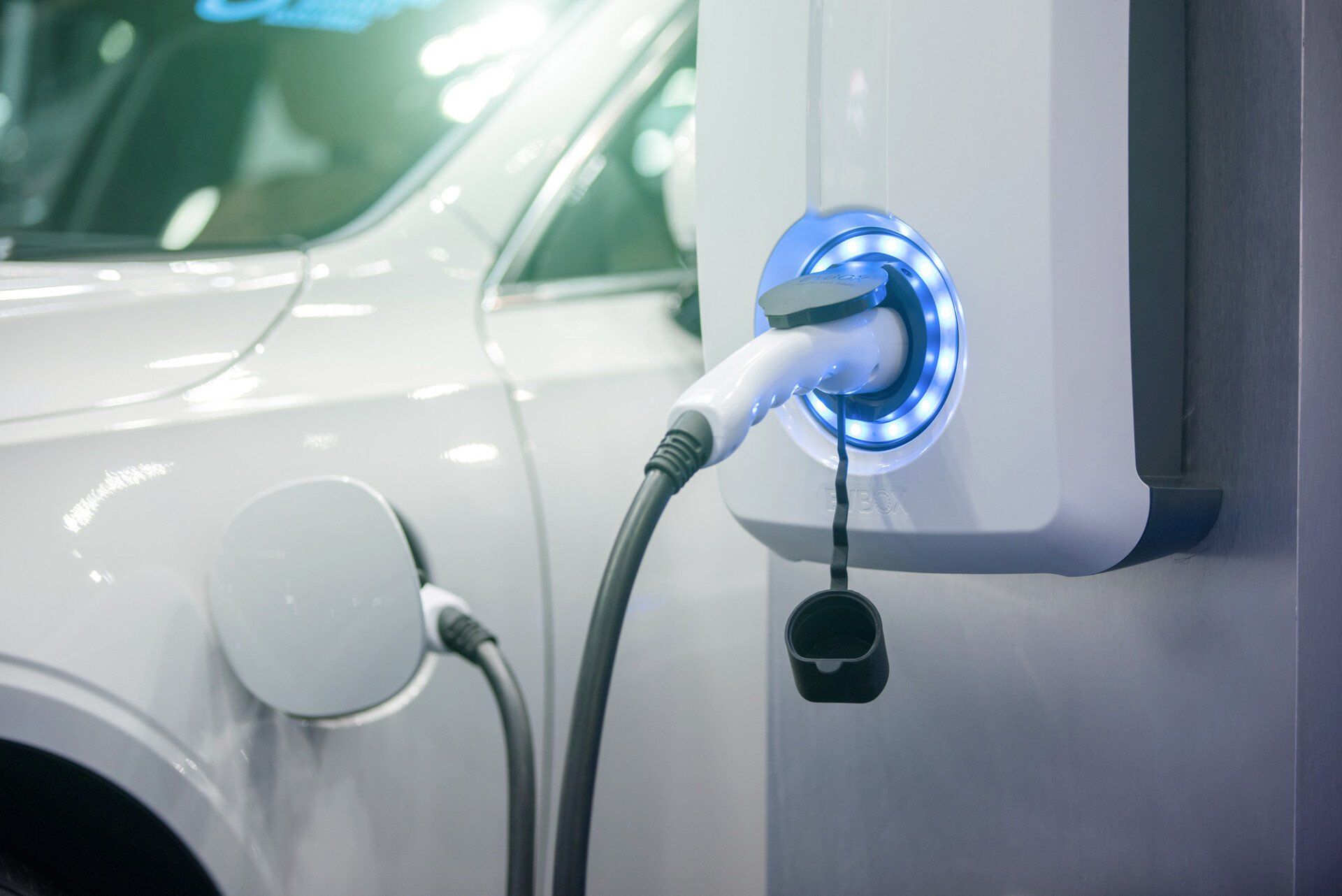 Power supply for electric car charging. Electric car charging station. Close up of the power supply plugged into an electric car being charged