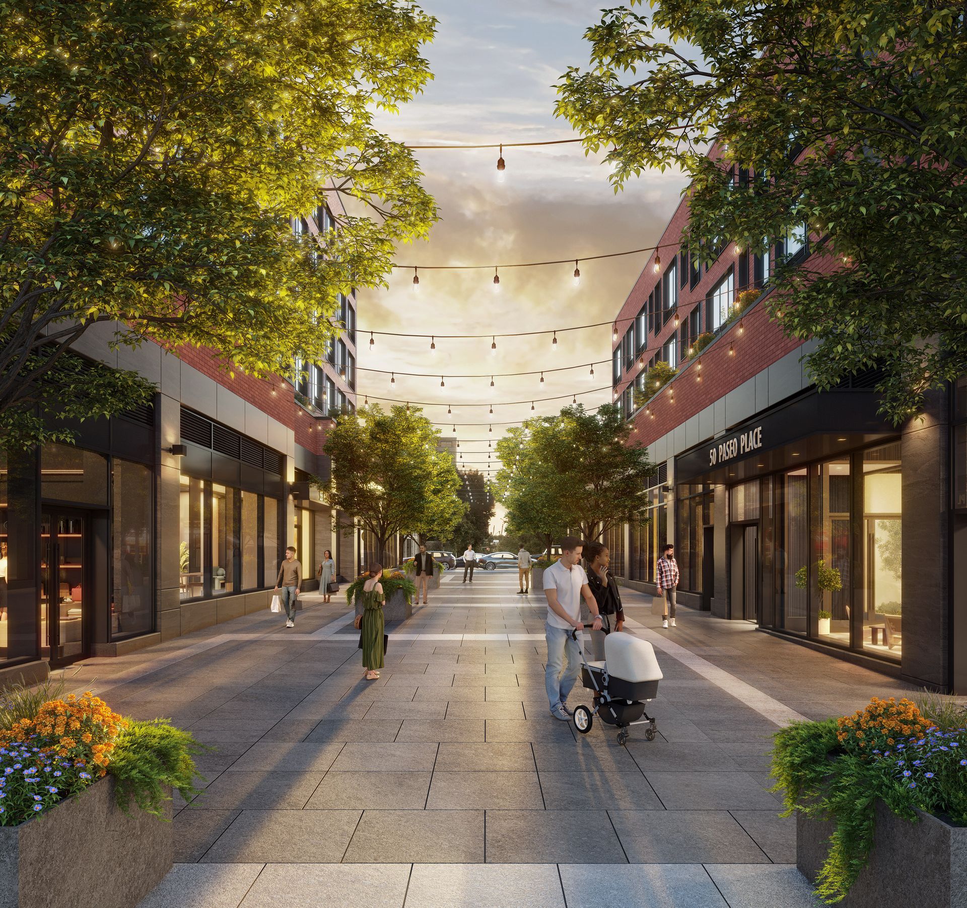 People strolling along a pedestrian walkway lined with shops and trees, with string lights overhead.