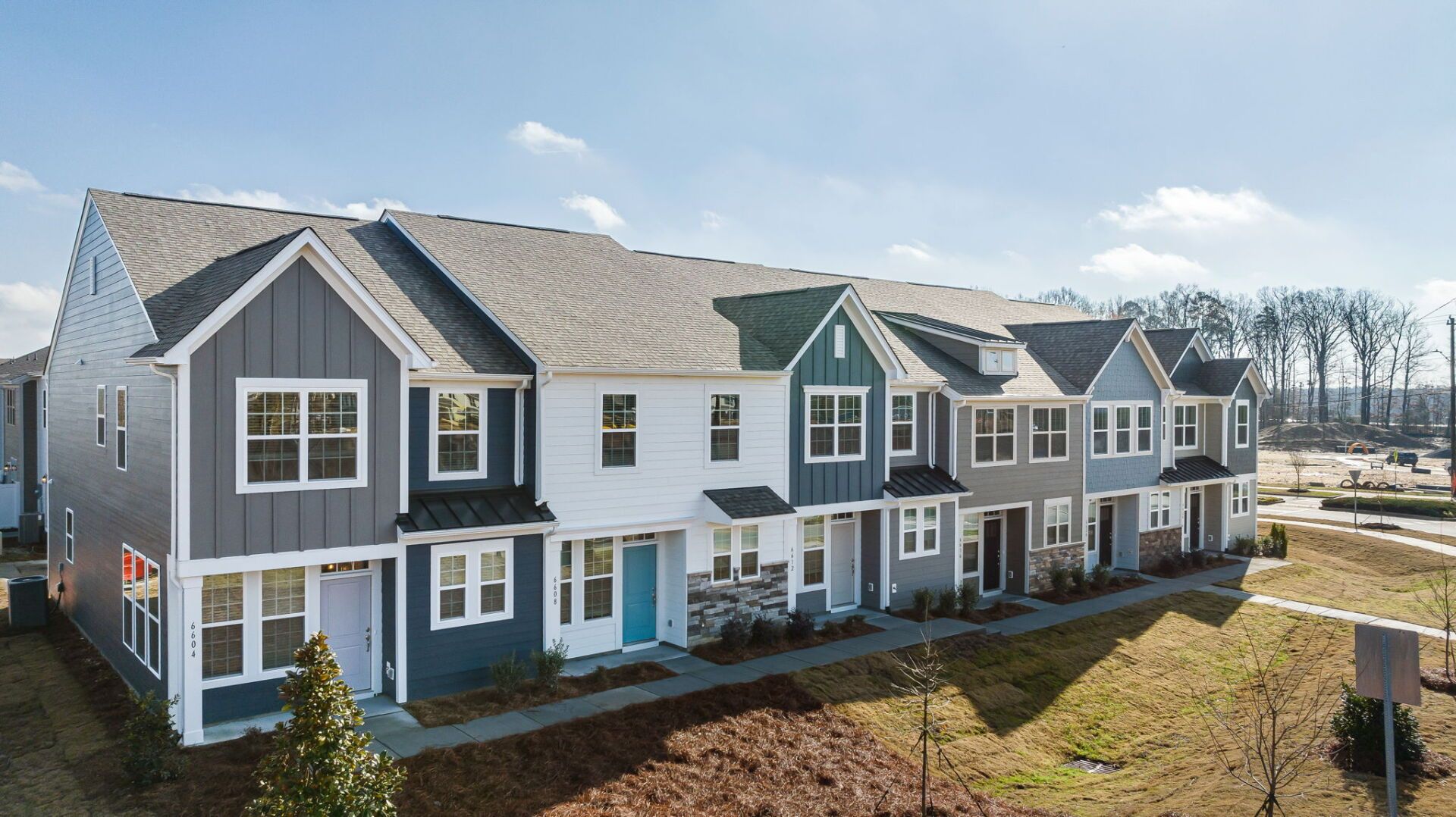 an aerial view of a row of houses on a sunny day .