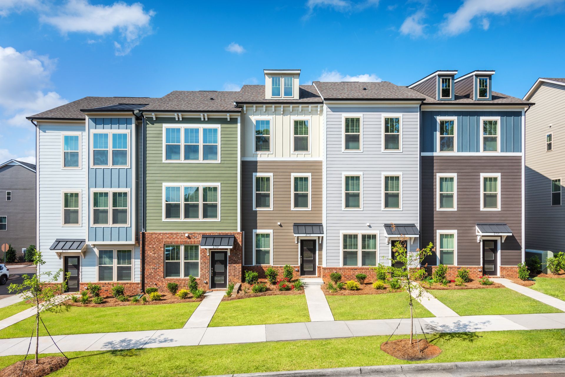 a row of apartment buildings with a lot of windows on a sunny day .