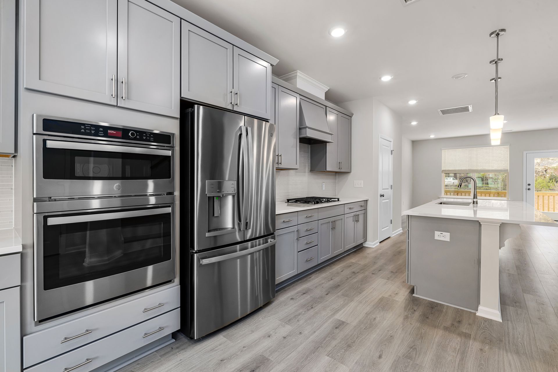 a kitchen with stainless steel appliances and white cabinets .