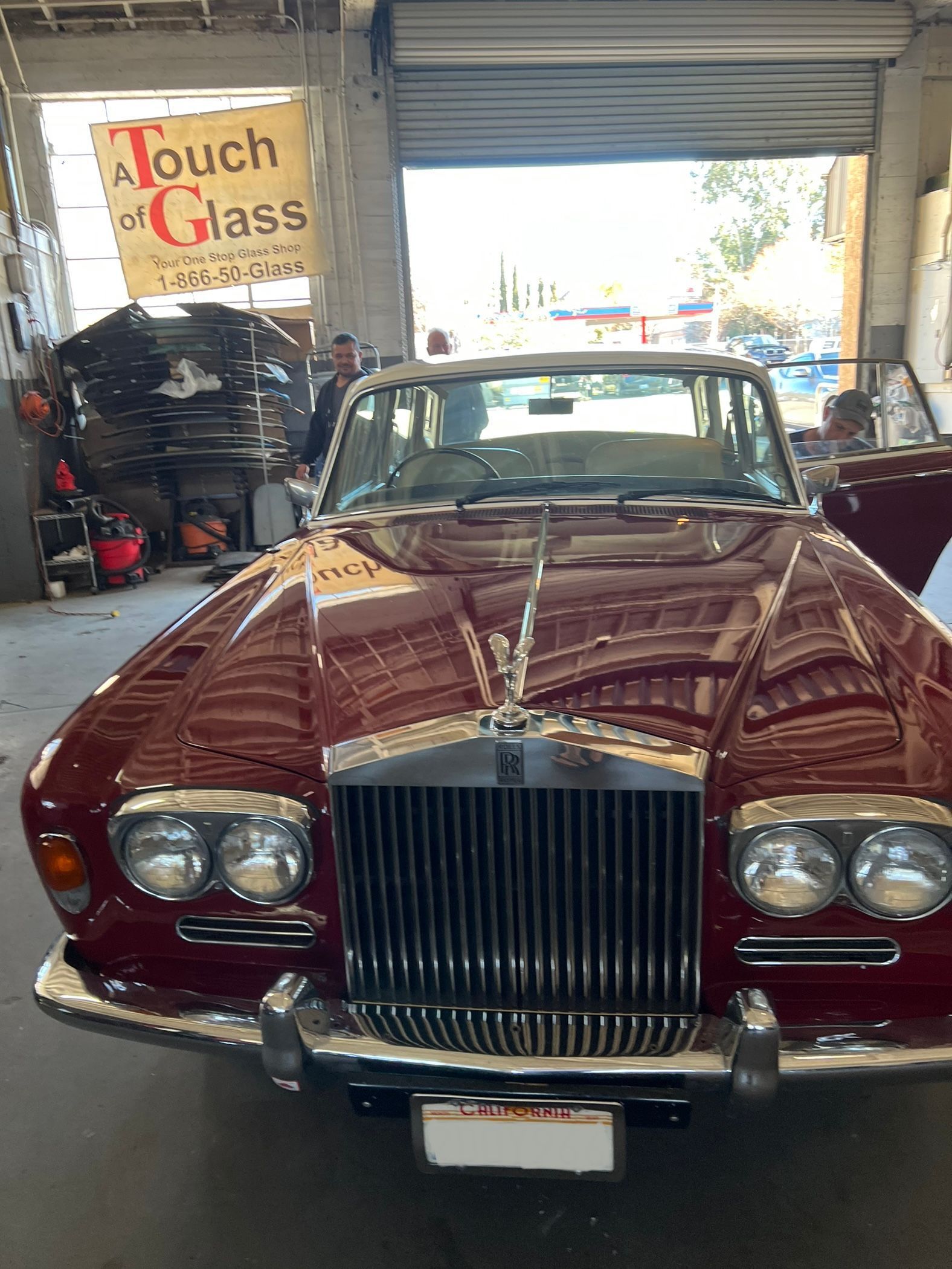Red Rolls-Royce convertible in a garage with