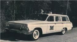 A white 1962 Chevrolet Bel Air station wagon with a large letter 