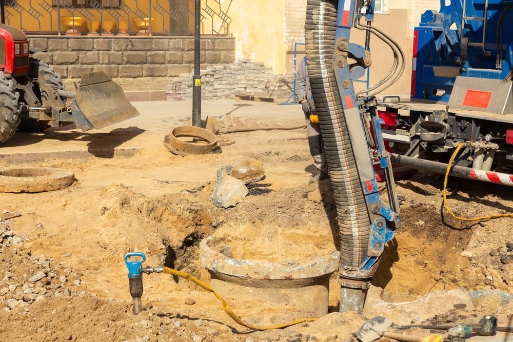 A tractor is digging a hole in the ground.