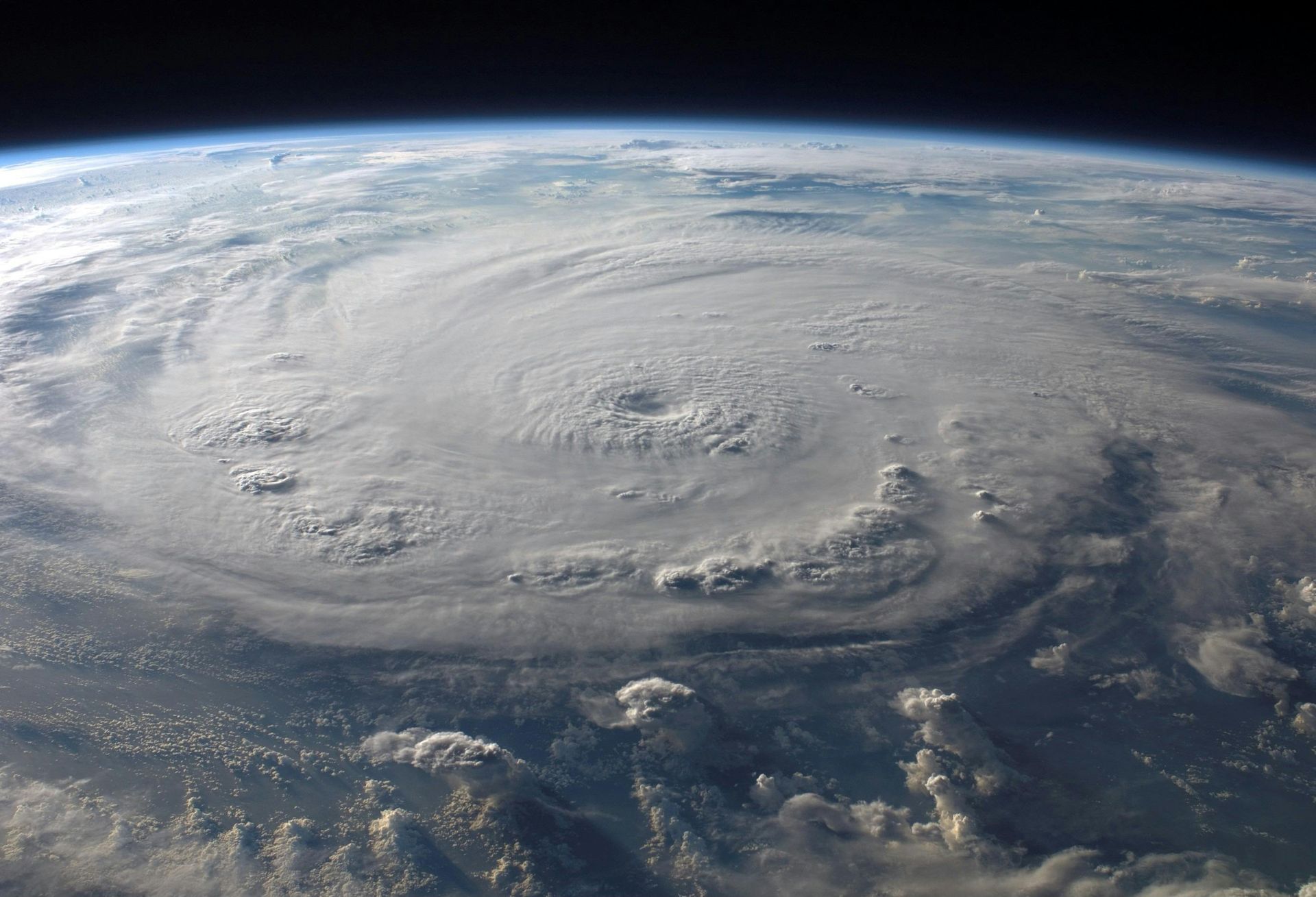 Hurricane over Earth, seen from space, swirling clouds, distinct eye.