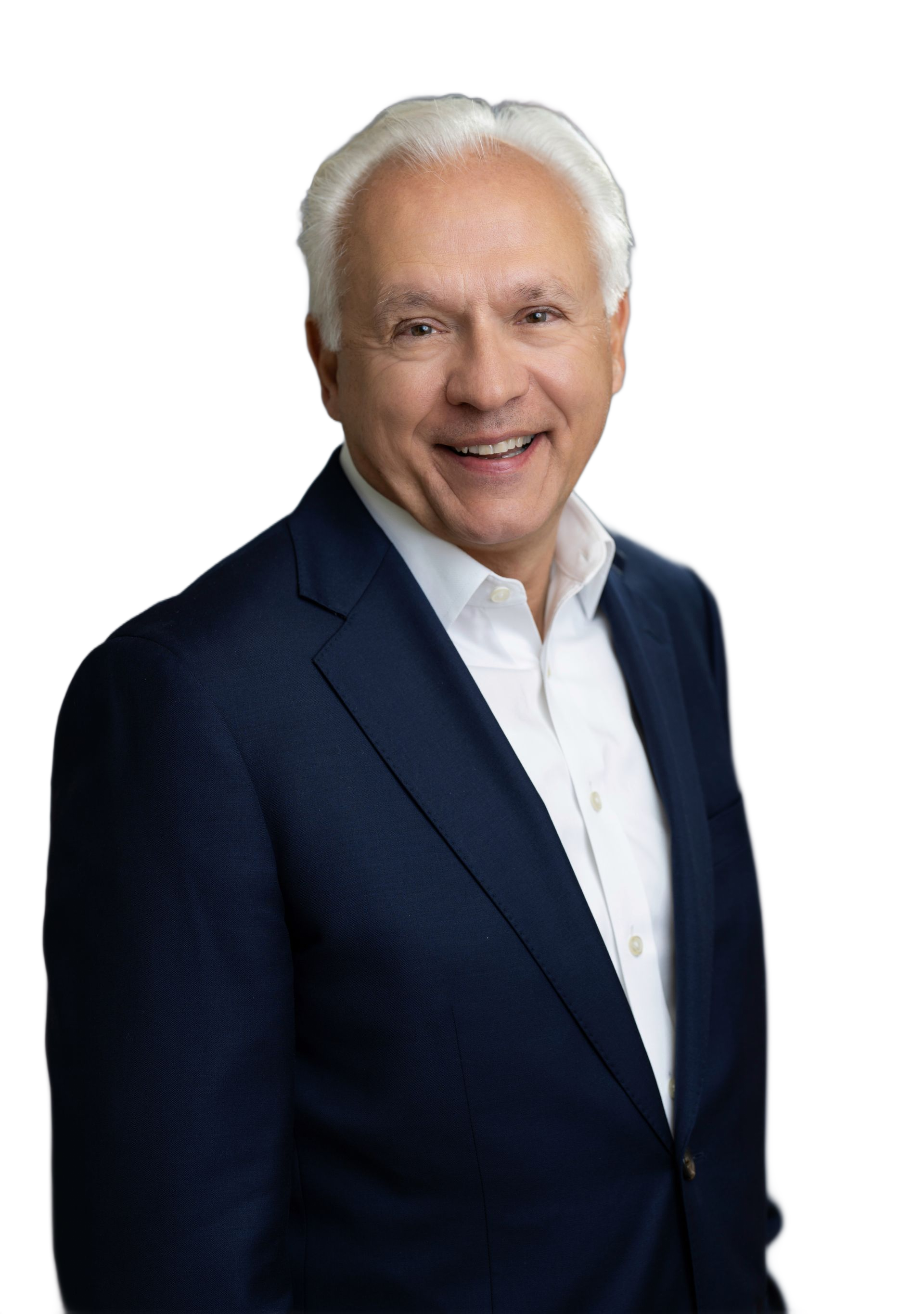 Smiling man with white hair and a navy suit, looking directly at the viewer.
