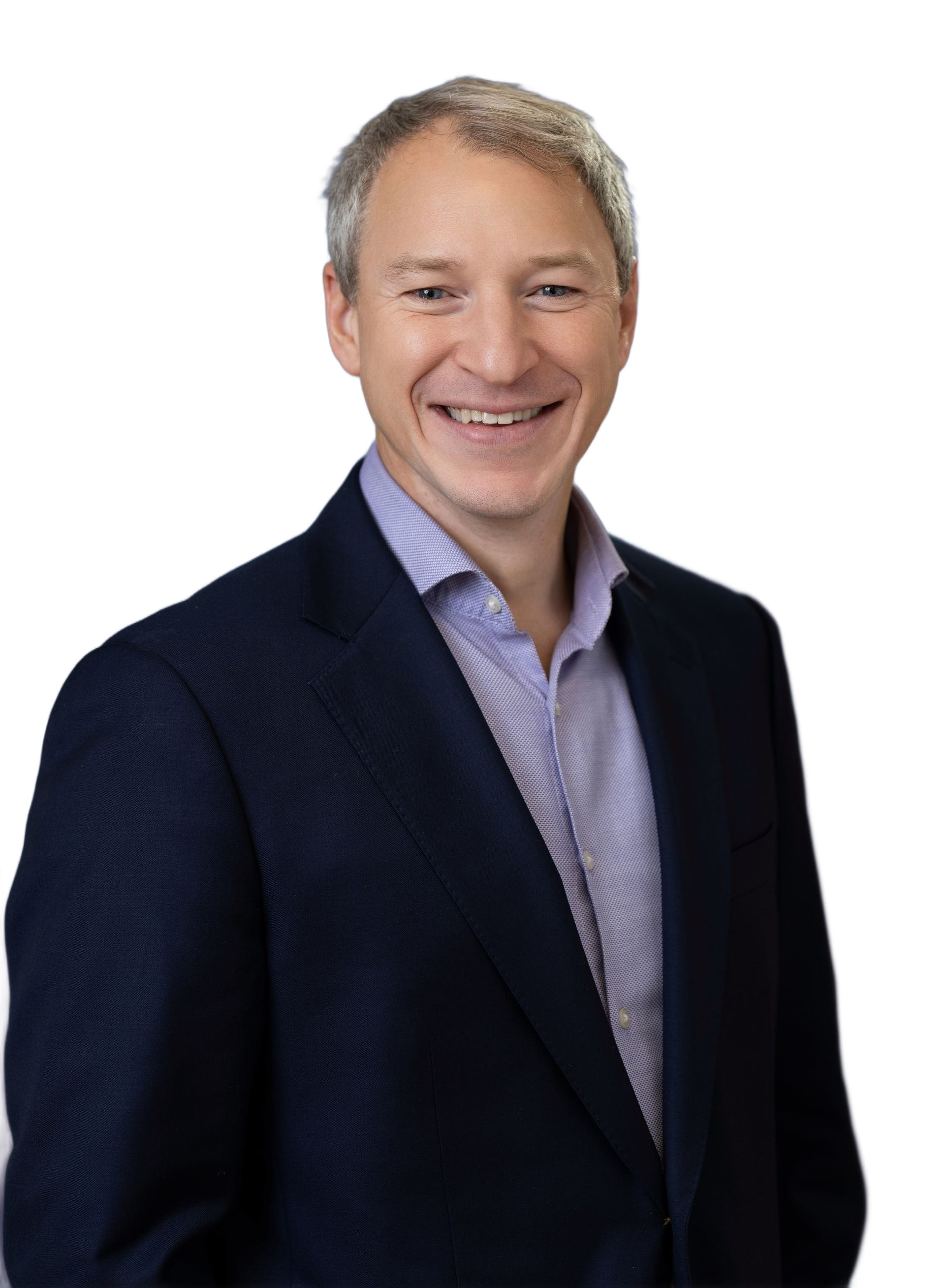 Smiling man in a suit and tie against a black background.