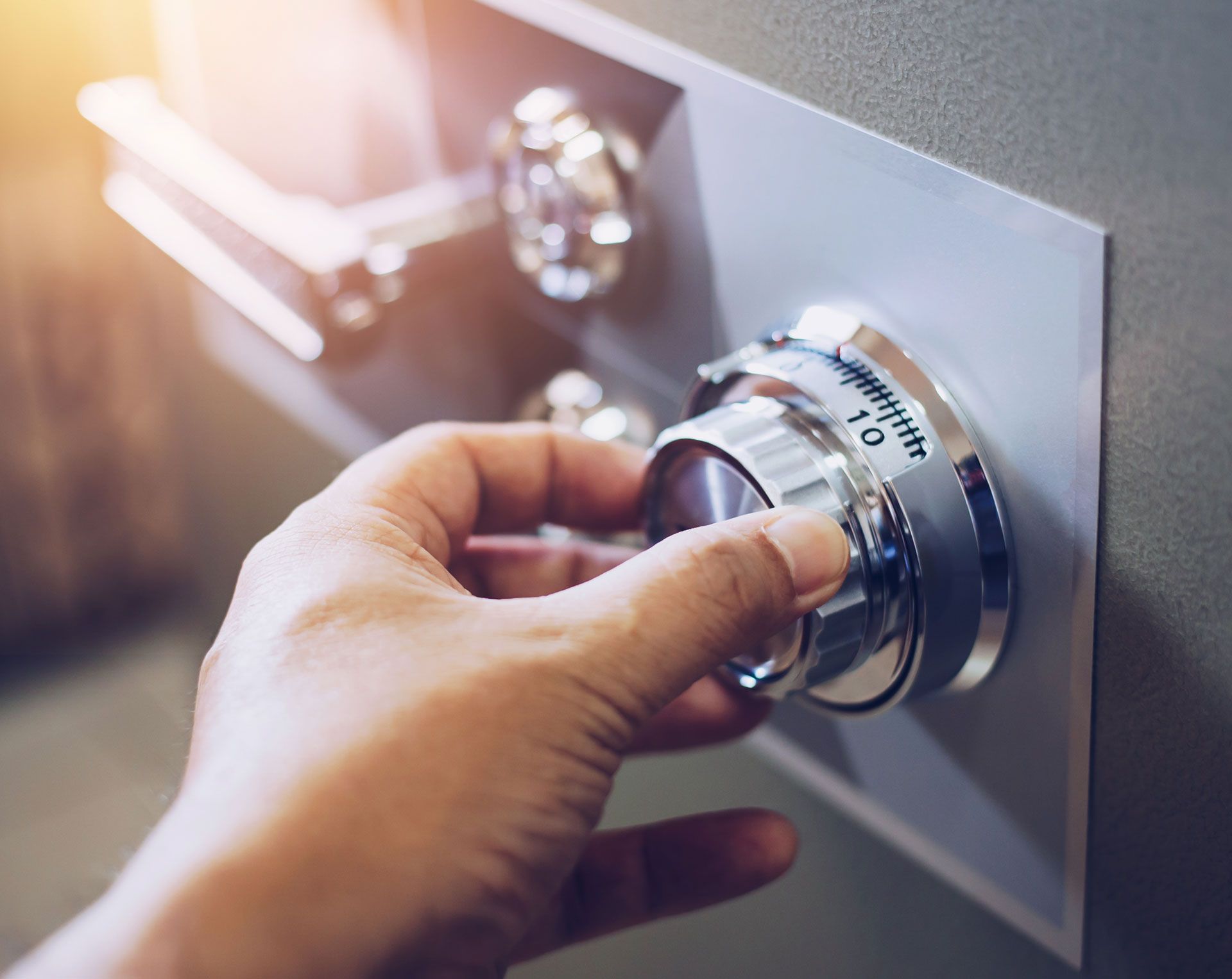 Hand turning the combination dial on a safe.