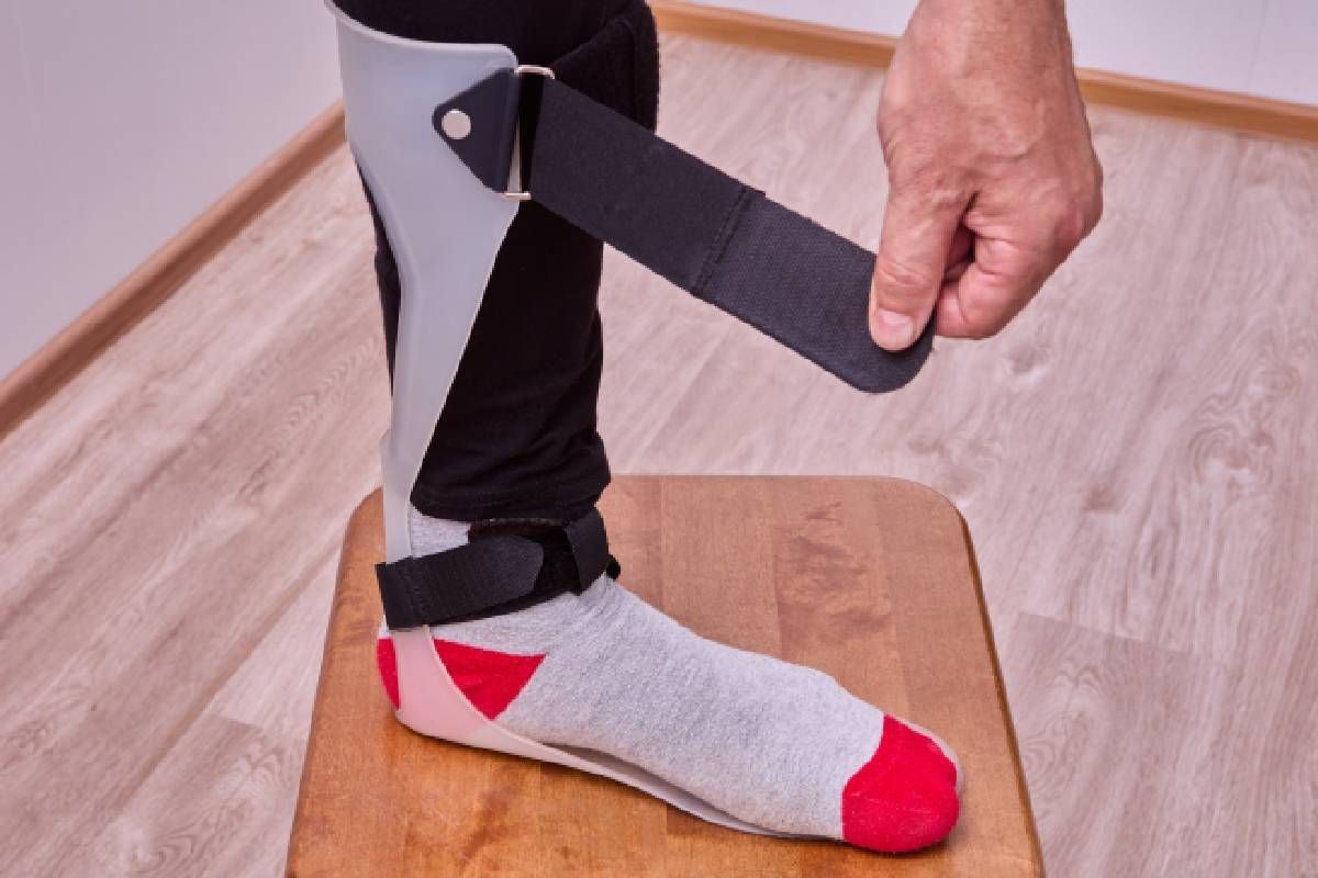 Client putting on AFO leg brace and ankle foot orthotic near Edgewood, Kentucky (KY)
