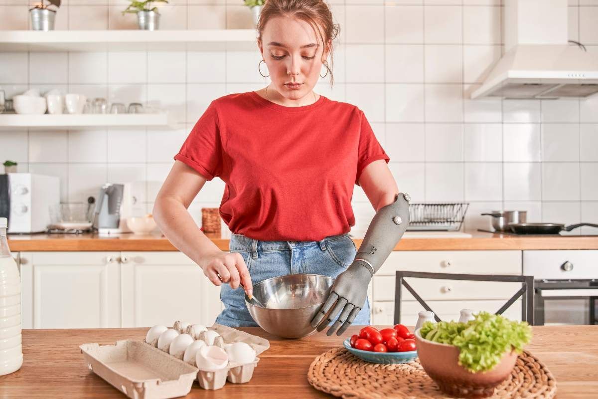 A person with a lower arm prosthetic cooking in a kitchen near Lawrenceburg, Indiana (IN)