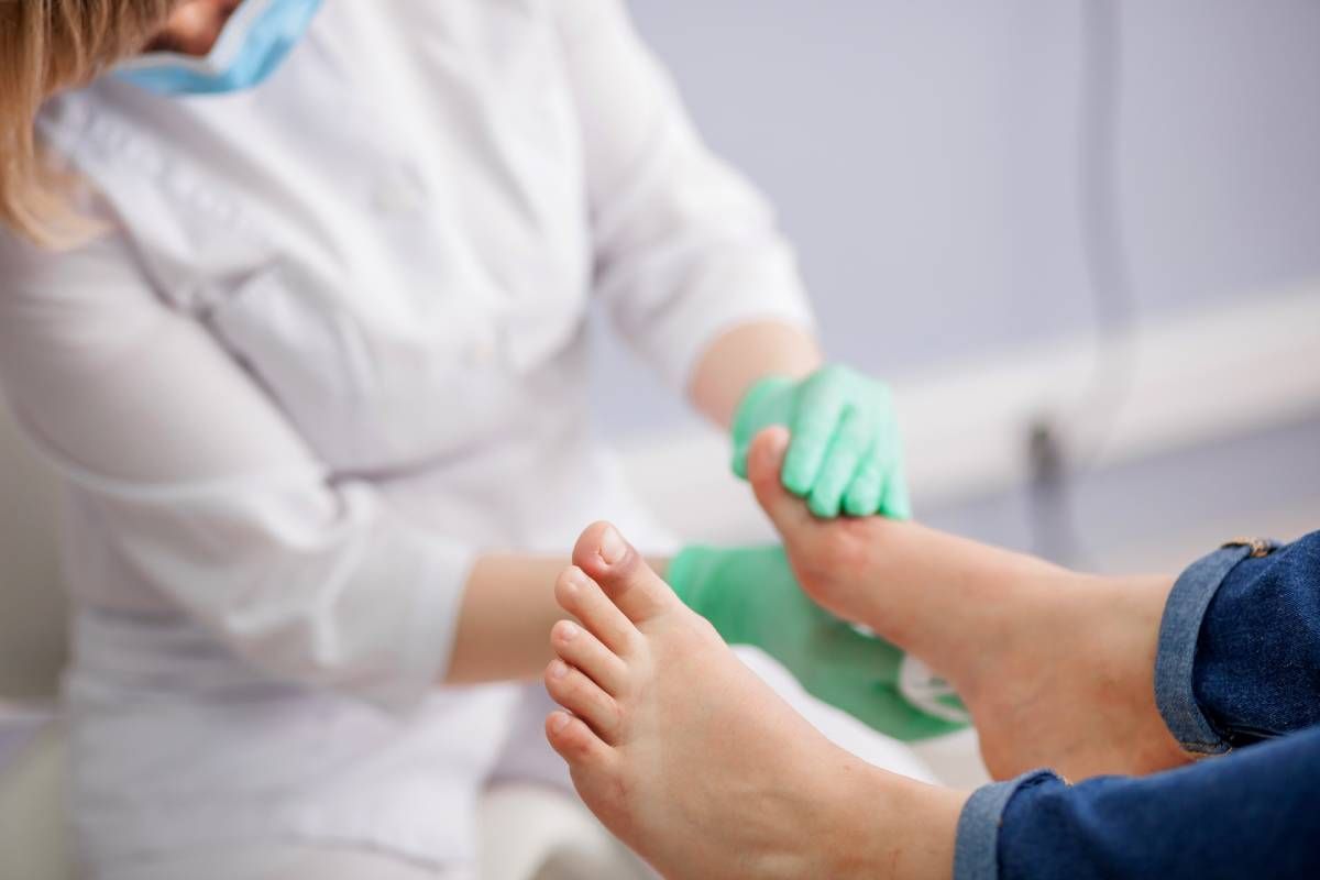  An orthotist reviewing a patient’s foot near Edgewood, Kentucky (KY) and Lawrenceburg, Indiana (IN)