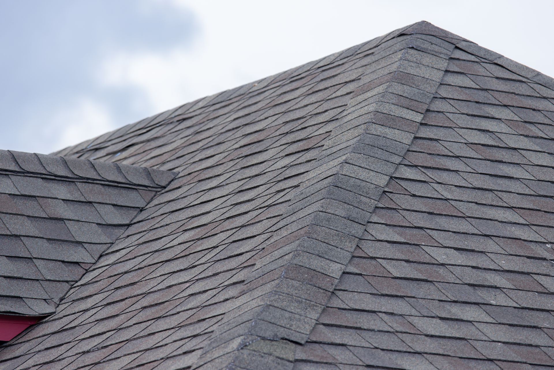 A close up of a roof with a blue sky in the background.