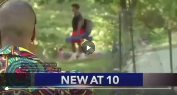 News broadcast frame of two people outdoors near a path, with “NEW AT 10” banner at bottom
