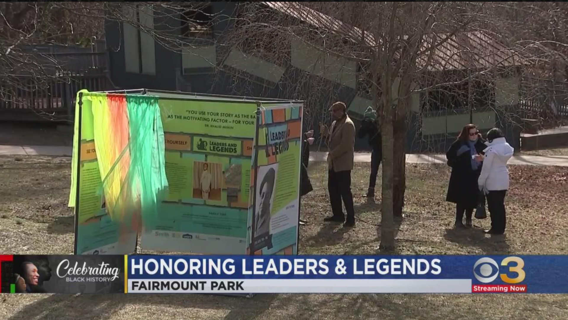 People gathered beside a colorful display at Fairmount Park for “Honoring Leaders & Legends.”