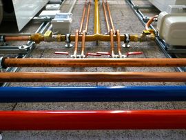 Color-coded industrial pipes and valves in a utility/mechanical room