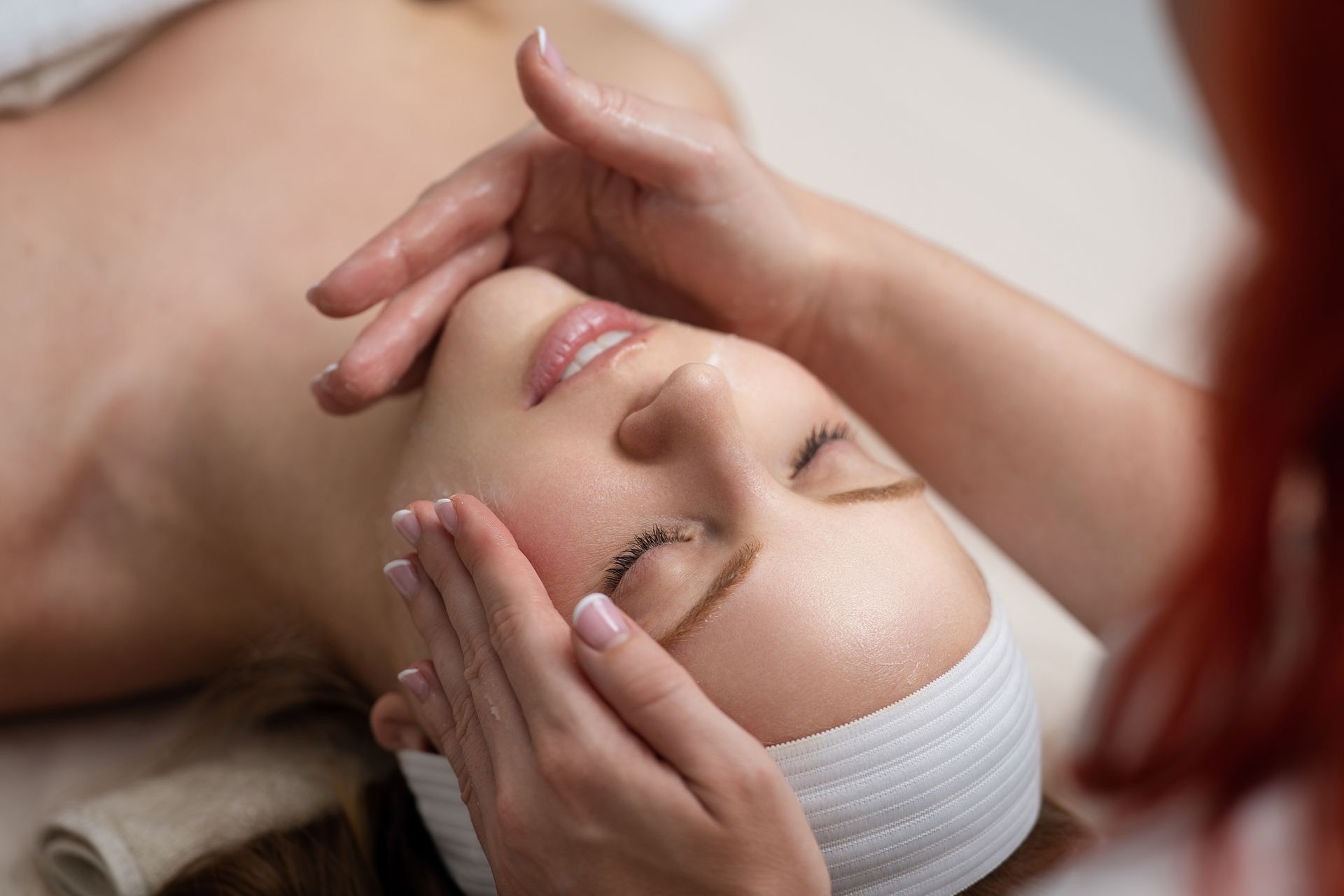 Woman receiving a facial massage.