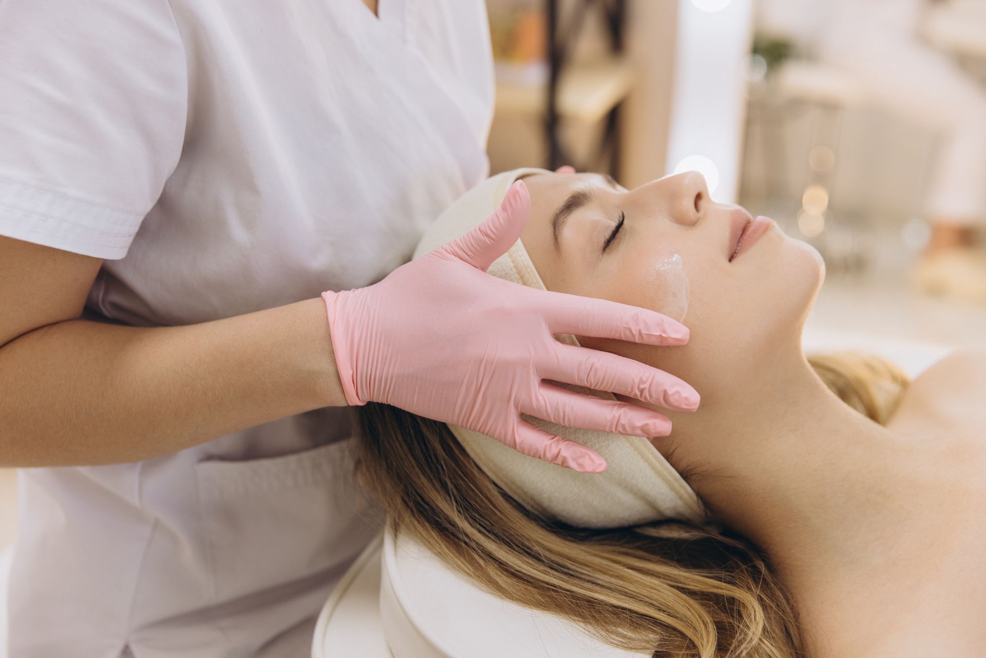 Woman receiving facial treatment.