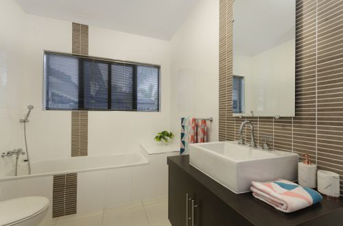Modern Bathroom With a White Sink, Brown Cabinets, and a Bathtub — George Pappas Painting In Buderim, QLD