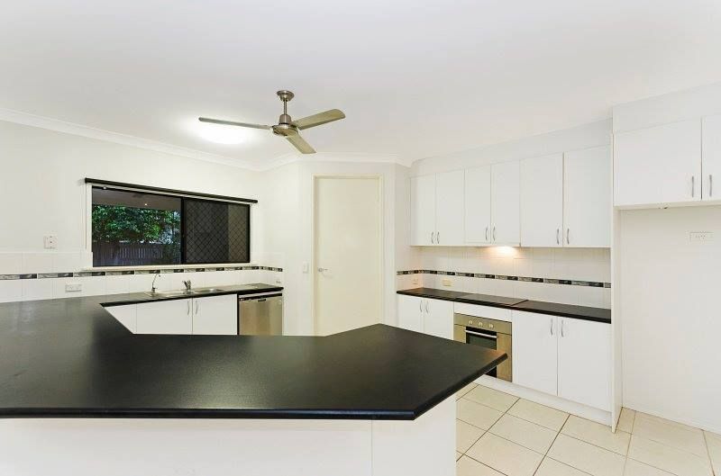 White Kitchen With Black Countertops, Cabinets, and Appliances — George Pappas Painting In Buderim, QLD