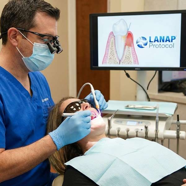 Expert periodontal procedure LANAP on a female patient