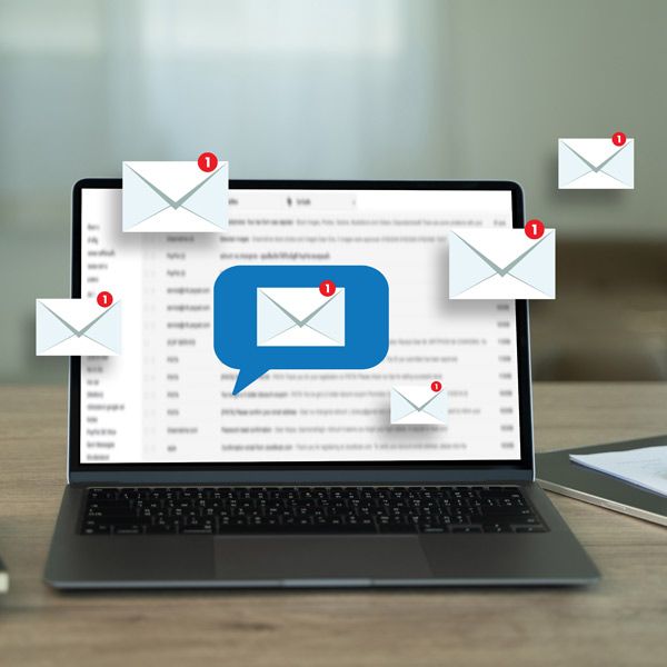 Laptop displaying email inbox with floating email icons and a speech bubble icon.