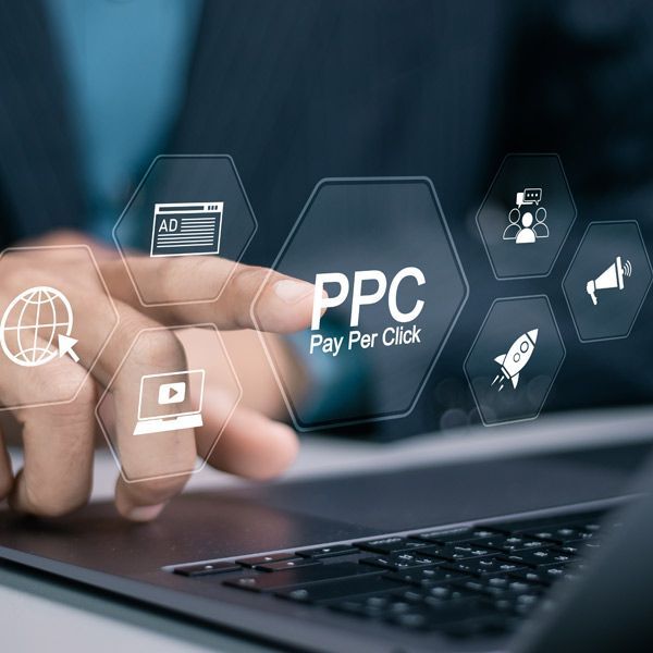 Person using laptop, interacting with PPC marketing icons, including an ad, rocket, and speaker.