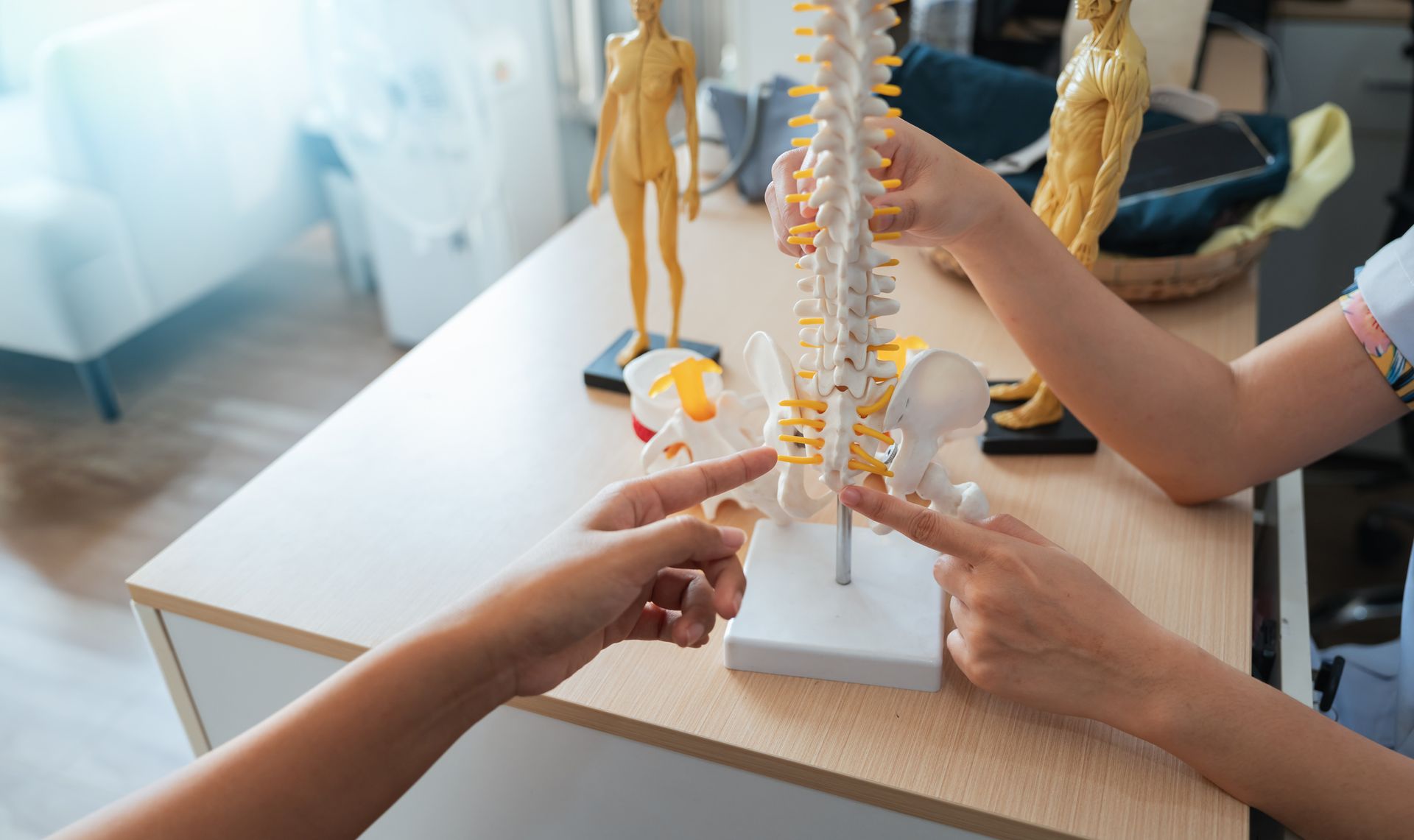 Person doing physical therapy with a red-lit knee treatment device on a treatment table