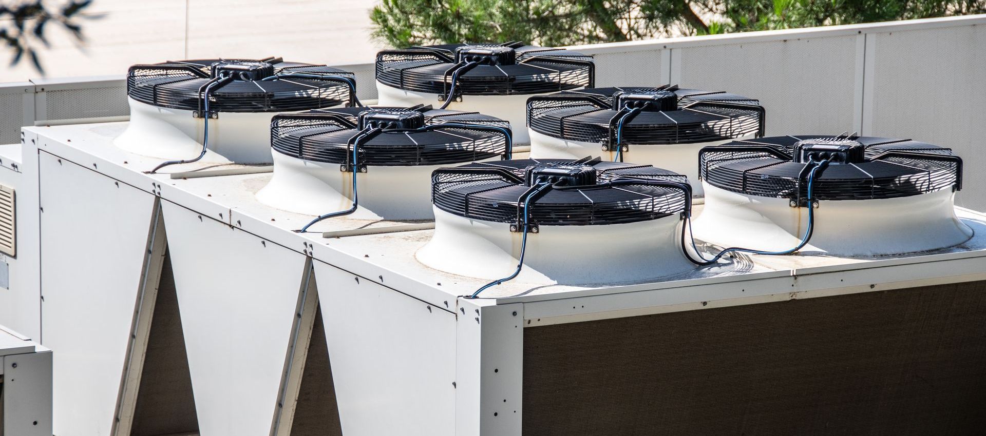 A bunch of fans are sitting on top of a building.