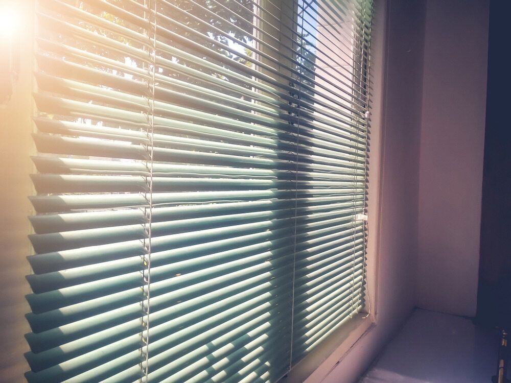 The Sun is Shining Through the Blinds of a Window — Atherton Decor Centre In Atherton, QLD