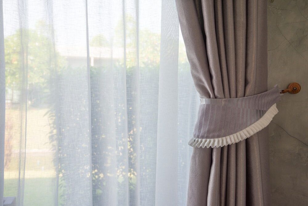 A Close Up of a Pair of Curtains Hanging on a Window — Atherton Decor Centre In Atherton, QLD