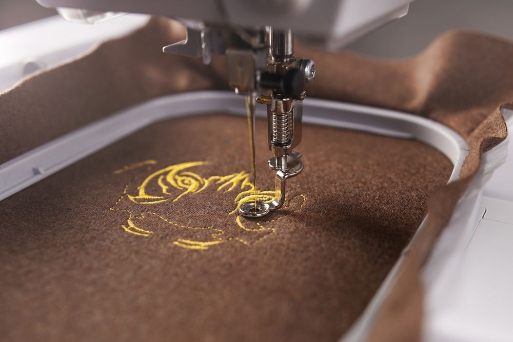 A close up of a sewing machine embroidery on a piece of fabric.