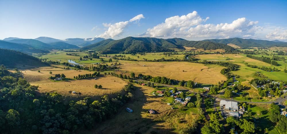 An Aerial View of a Lush Green Valley With Mountains in the Background — Bonanno's Menswear in Heathcote, NSW