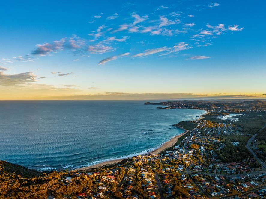 An Aerial View of a Beach With a City in the Distance — Bonanno's Menswear in Shellharbour, NSW